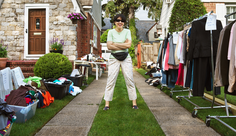 Homeowner comparing DIY rubbish clearance costs against professional removal quotes at kitchen table